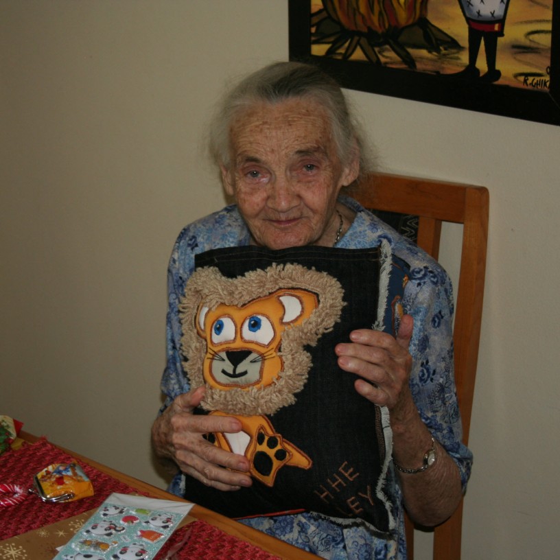 My mother at age 95, hugging a cushion, a gift from my daughter